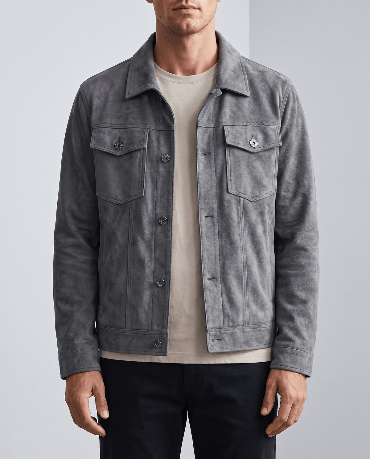 A man wearing a gray soft suede jacket with chest pockets and side pockets