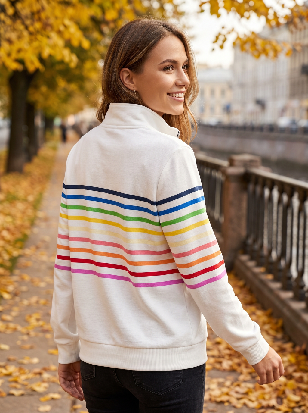 White brushed cotton half-zip sweatshirt featuring colorful horizontal stripes, a stand collar, and ribbed trim.
