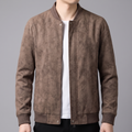 A man wearing a brown suede bomber jacket with a full-zip front and ribbed trim