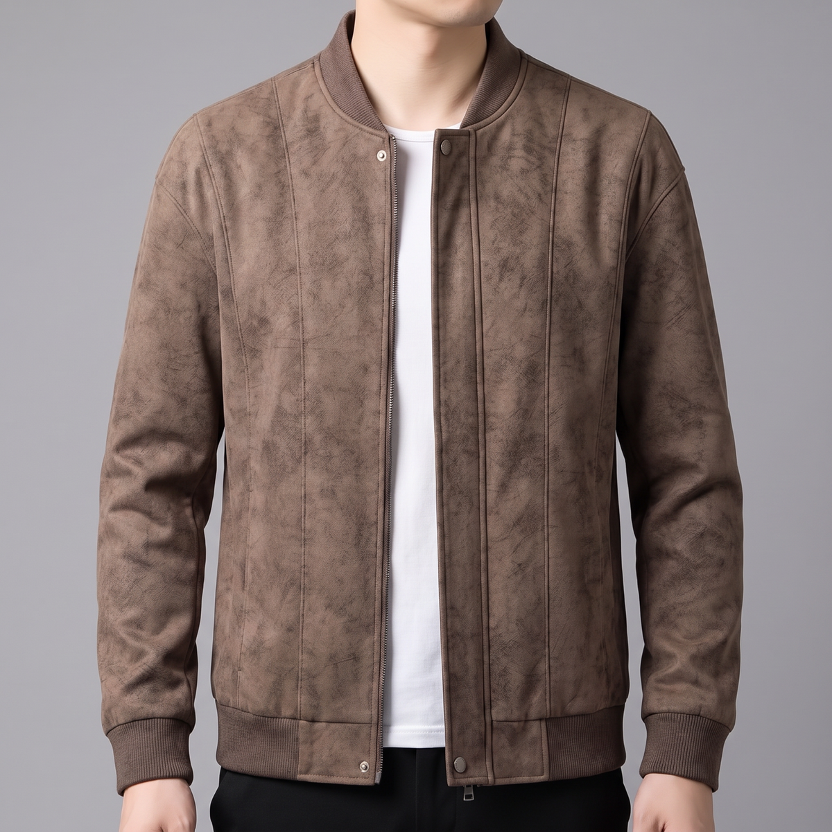 A man wearing a brown suede bomber jacket with a full-zip front and ribbed trim