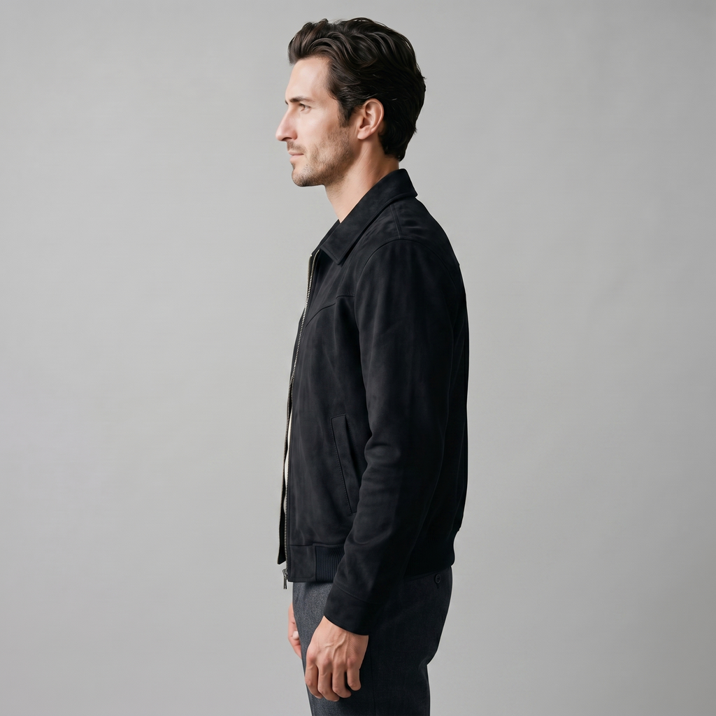 A man wearing a black suede Harrington bomber jacket with a full-zip front and point collar, shown in side view