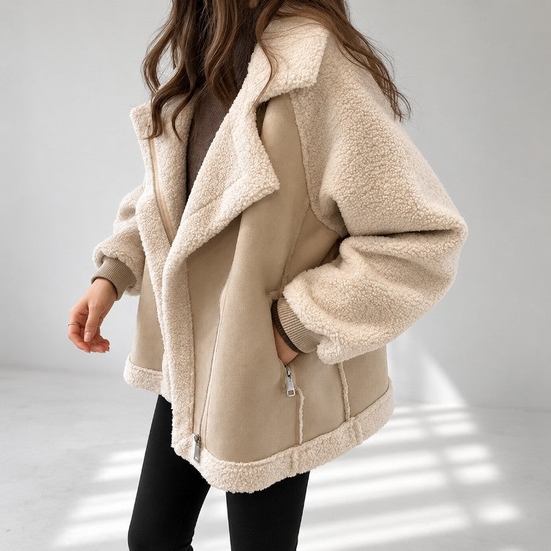 Beige vegan suede aviator jacket with contrast cream sherpa sleeves, oversized notch lapel, and ribbed knit cuffs.