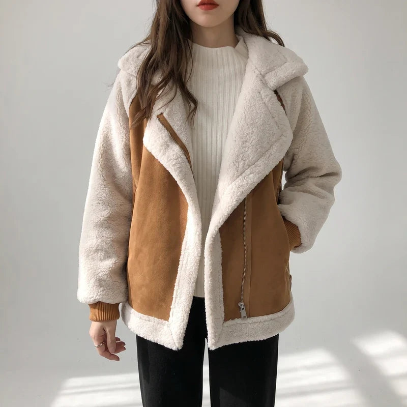 Tan vegan suede aviator jacket with contrast cream sherpa sleeves, oversized notch lapels, and ribbed cuffs.