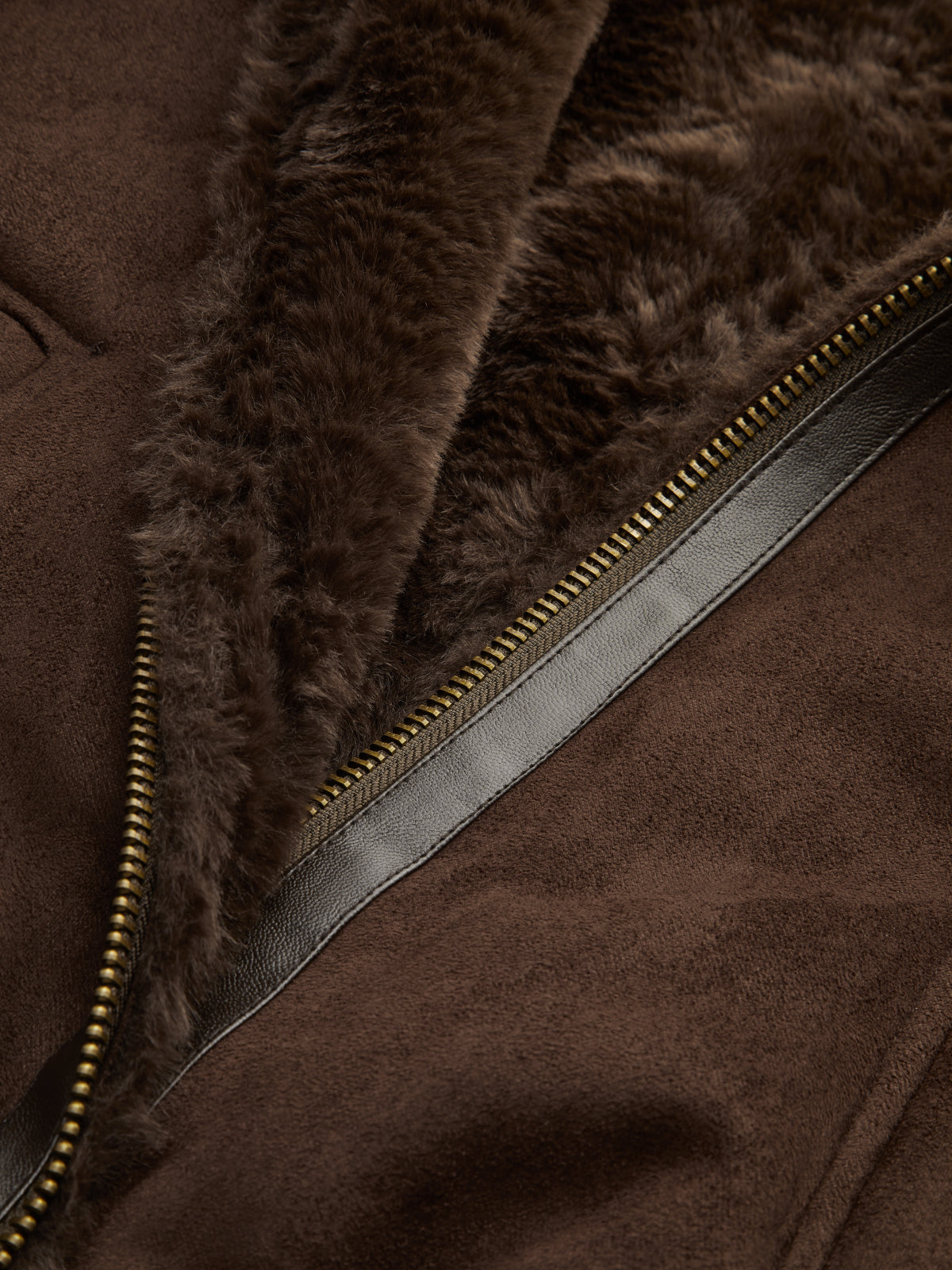 Brown vegan suede aviator jacket featuring a plush dark brown sherpa collar, smooth leather trim, and a brass-tone zipper.