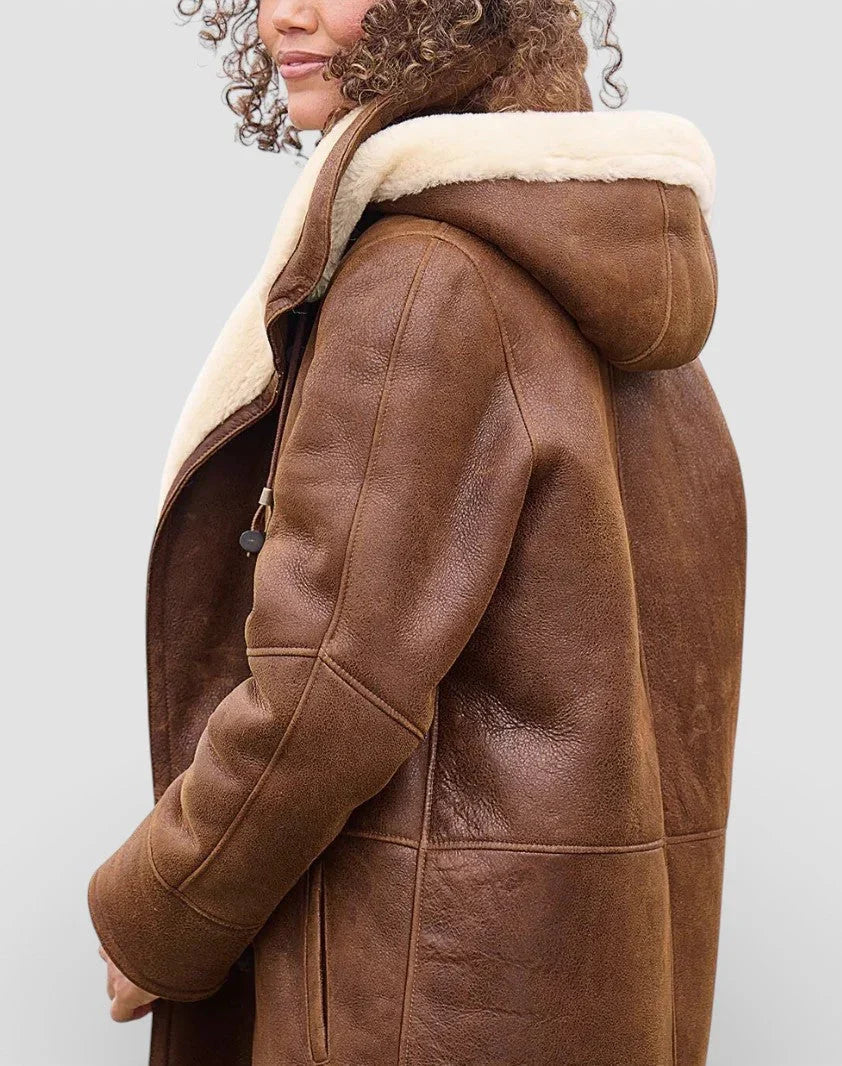 Brown vegan suede duffle coat with a plush cream sherpa lining, hood, and toggle front closure.