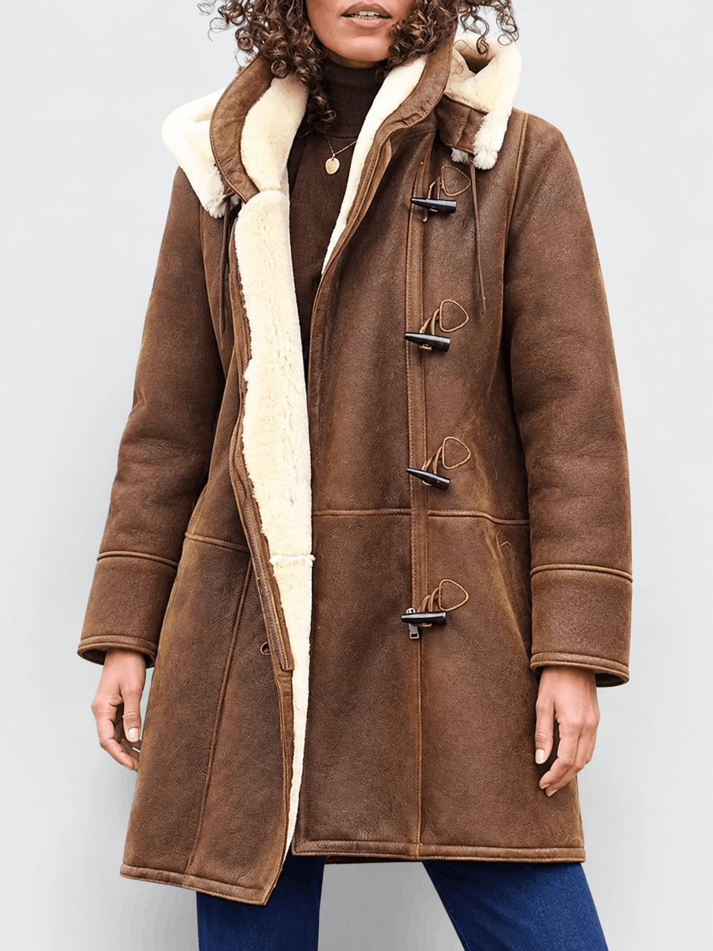 Brown vegan suede duffle coat with cream sherpa lining, toggle fastenings, and a structured, hip-length fit.
