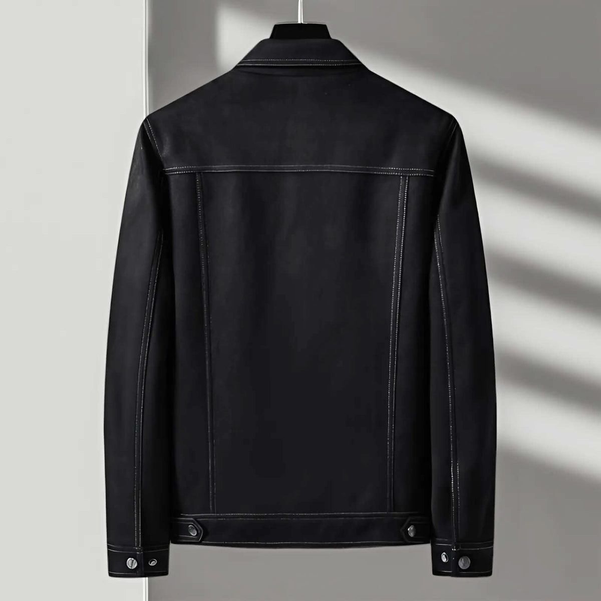 A black suede trucker jacket with a point collar and button-front closure, shown from the back