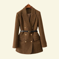 Women's brown herringbone blazer with a double-breasted button closure, notched lapels, flap pockets, long sleeves, and belted waist.
