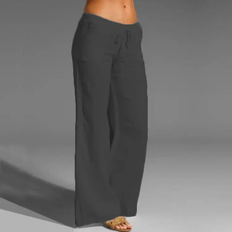 Women's black wide-leg linen pants with a drawstring waistband, loose fit, and flowing wide-leg design.