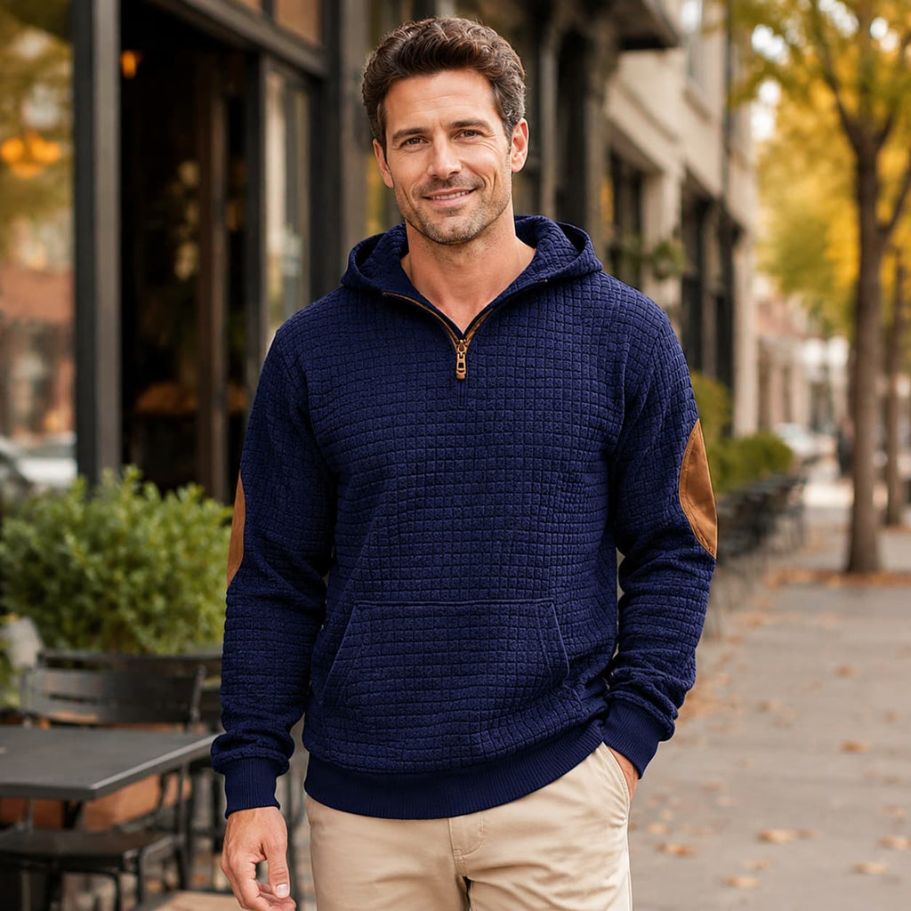 Navy blue textured check quarter-zip pullover with contrast brown elbow patches and a kangaroo pocket.