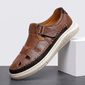 Single brown leather Toby fisherman sandal with cutout side panels and chunky white platform sole, angled on a white block against a studio backdrop