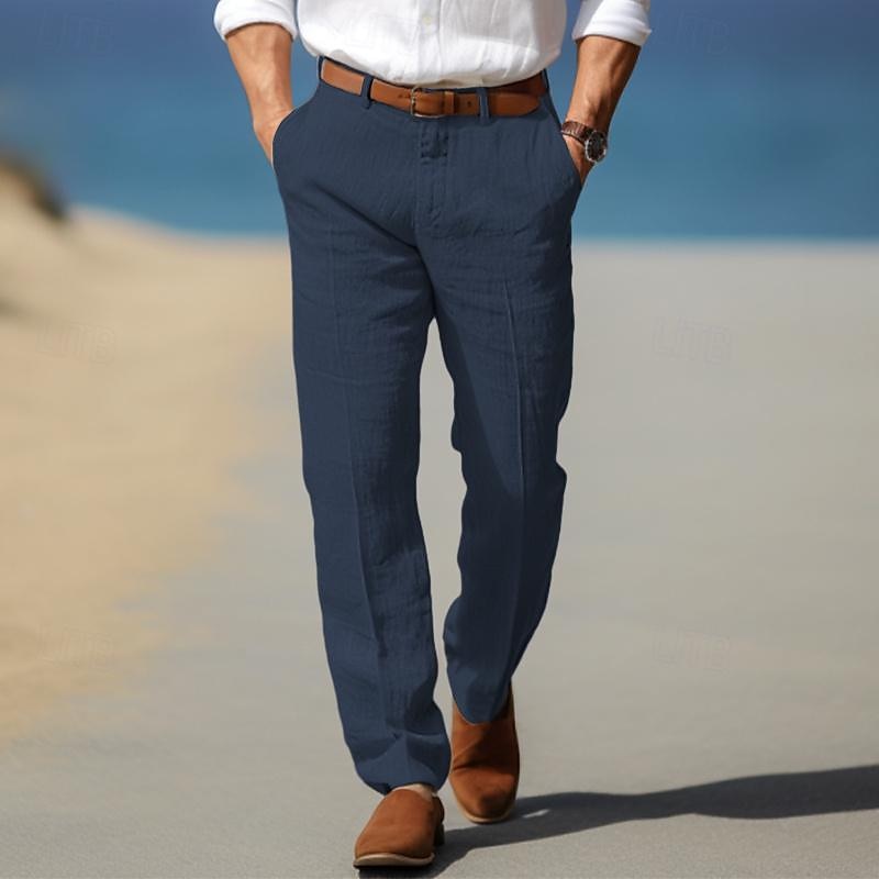 Man wearing navy linen trousers featuring a relaxed straight-leg fit, pleated front, and lightweight construction.