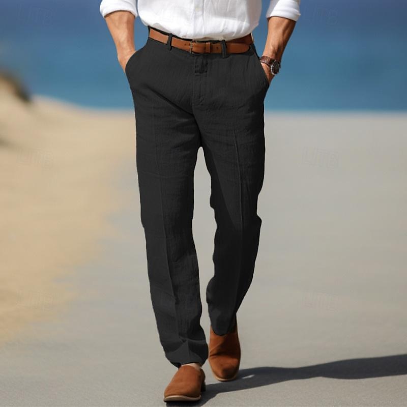 Man wearing black linen trousers with a tailored straight-leg silhouette, pleated front, and side pockets.