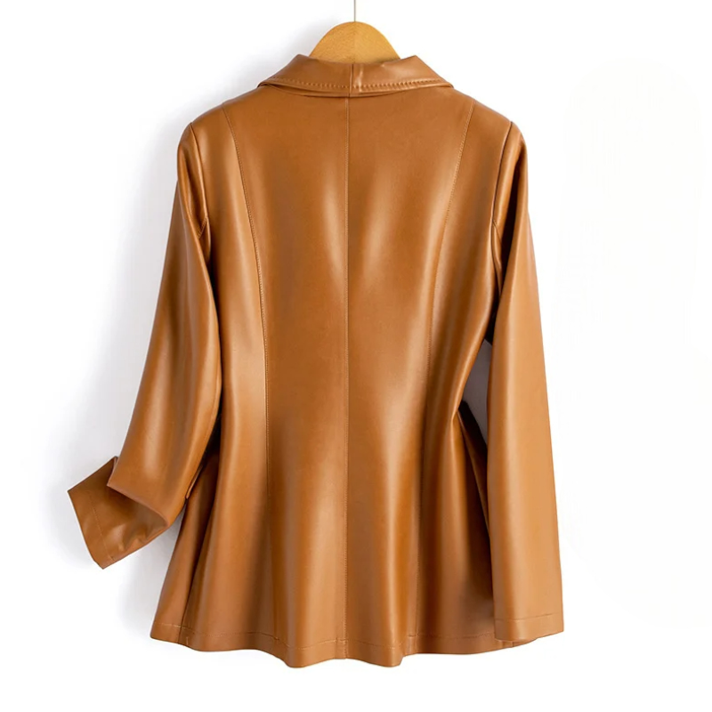 Back view of the caramel vegan leather blazer showing the framing seam detail across the shoulders