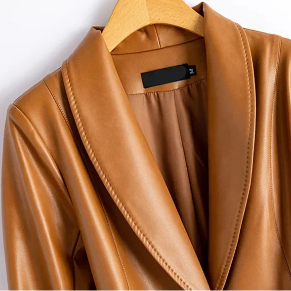 Close-up of the caramel vegan leather blazer's wide shawl lapel and topstitched edge detail