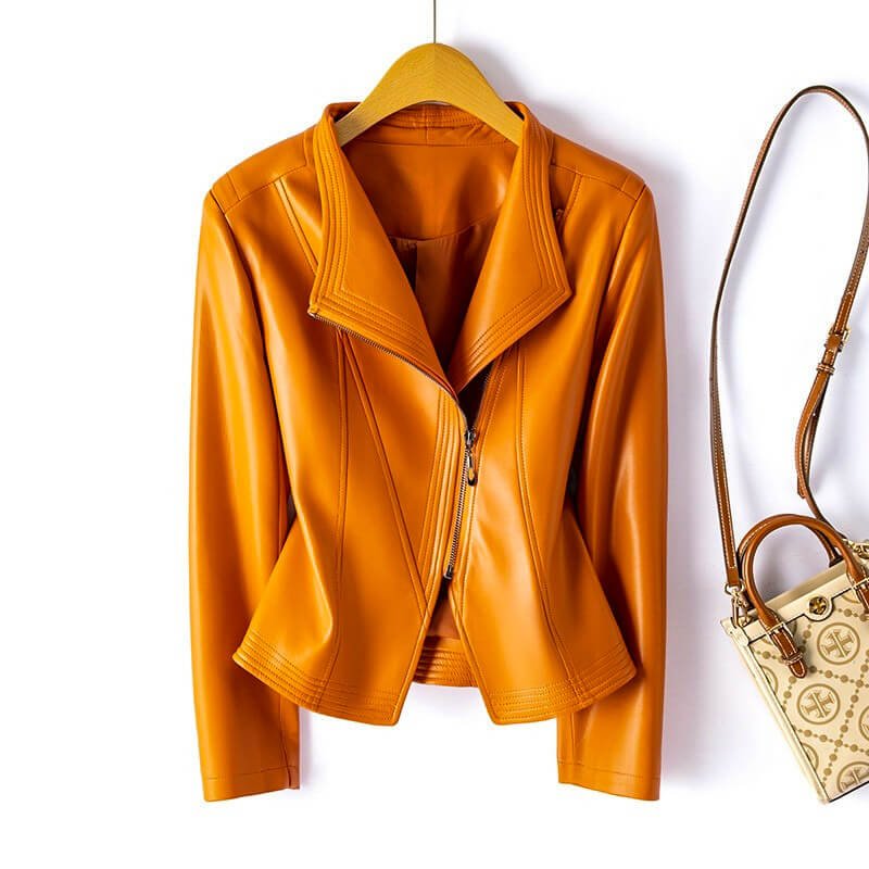 Valeria Vegan Leather Jacket in Saffron Orange hanging on display