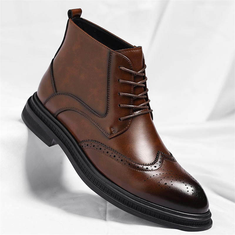 A brown leather brogue lace-up ankle boot with wingtip perforation detailing, shown on a white sheet.