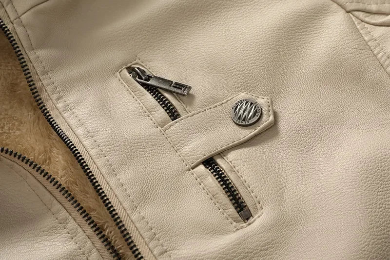 Close-up of the beige hooded leather jacket showing the zippered chest pocket, snap-button tab, and premium stitching.