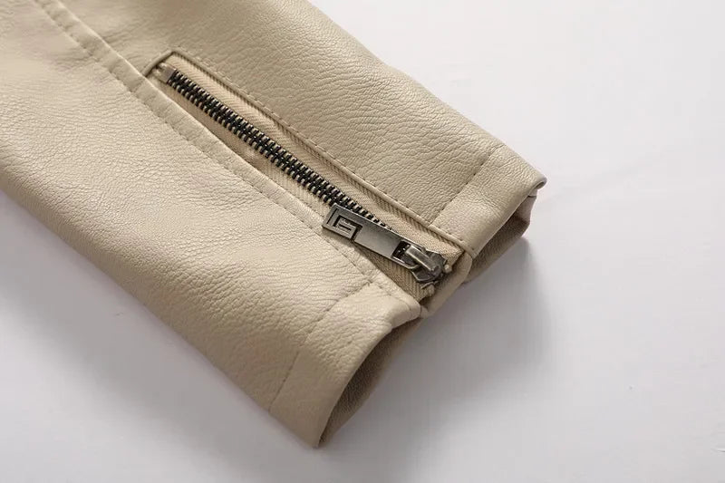 Close-up of the beige hooded leather jacket sleeve featuring a zippered cuff and smooth leather finish.