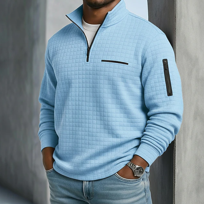 Light blue waffle-knit quarter-zip sweater with a relaxed fit, featuring a chest pocket and zippered sleeve detail.