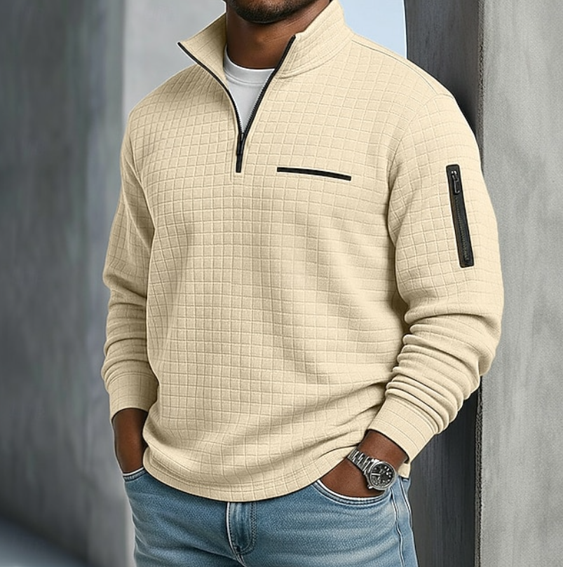 Beige waffle-knit quarter-zip sweater with a relaxed fit, black zipper accents, and a textured grid pattern.