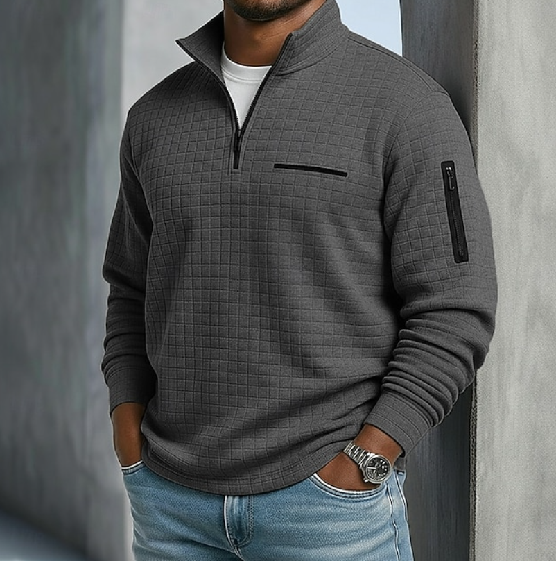 Charcoal gray waffle-knit quarter-zip sweater with a relaxed fit, zip sleeve pocket, and textured grid pattern.