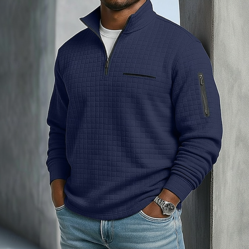 Navy blue waffle-knit quarter-zip sweater with a relaxed fit, zip sleeve pocket, and textured grid pattern.