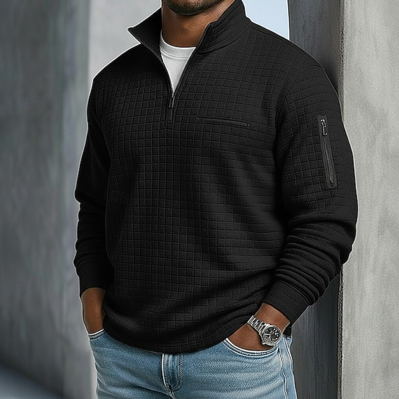 Black waffle-knit quarter-zip sweater with a relaxed fit, textured grid pattern, and zippered utility sleeve pocket.