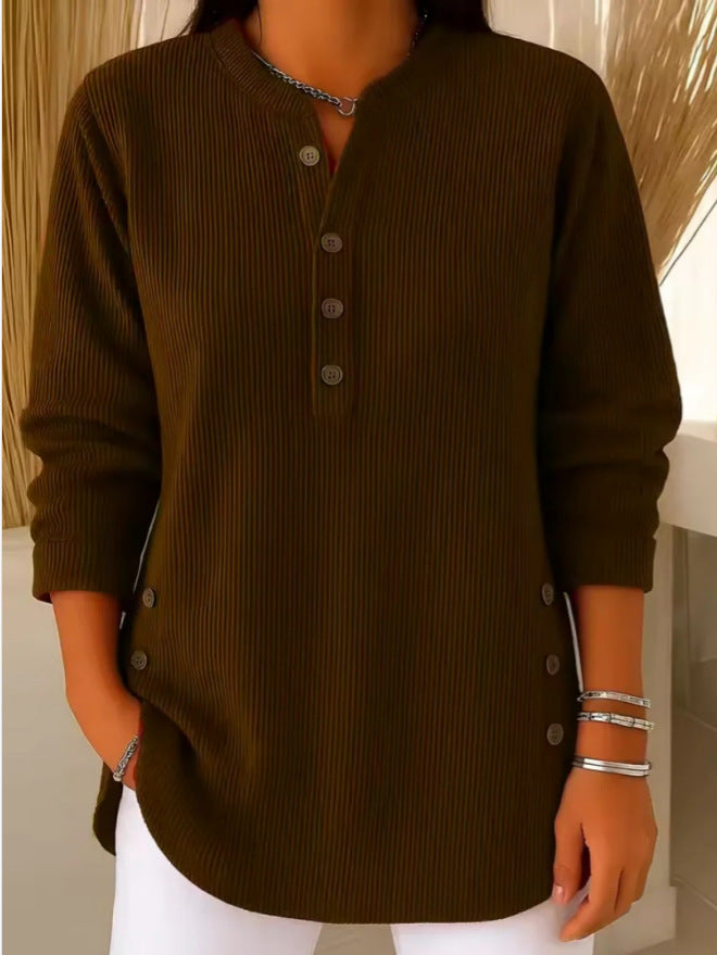 Woman wearing a dark brown waffle knit Henley sweater featuring a split neckline, button placket, side button accents, and a relaxed silhouette.
