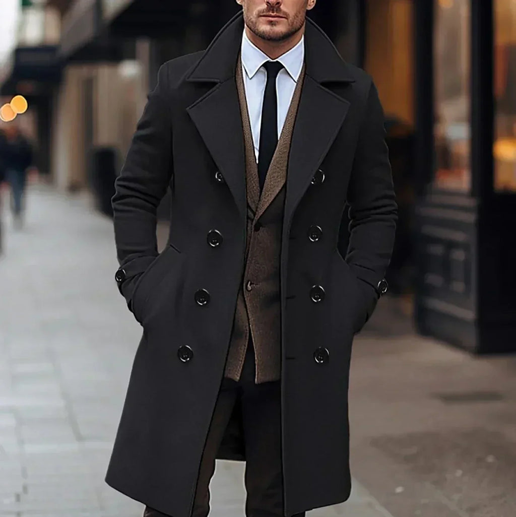 Black wool double-breasted trench coat with structured lapels and a tailored mid-length fit worn over a brown suit.