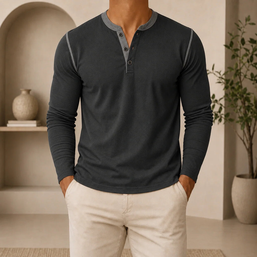 Man wearing a charcoal long-sleeve Henley sweater featuring a contrast brown placket, three-button neckline, and classic slim fit.