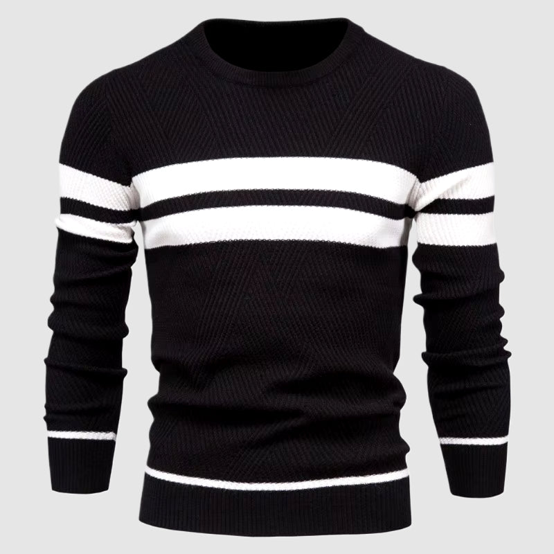 Man wearing black and white striped crewneck knit sweater, studio close-up torso view on grey background