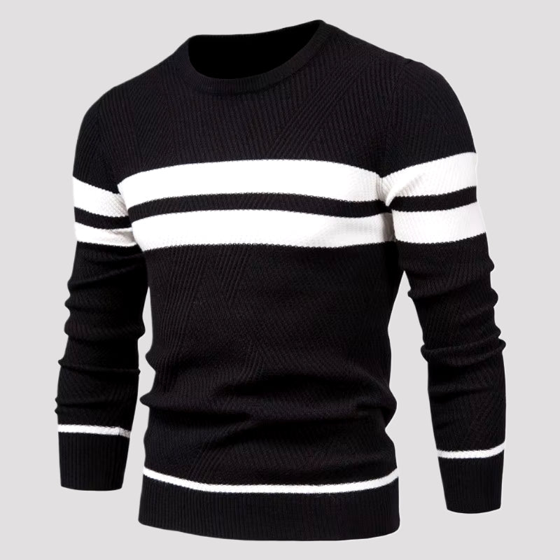 Man wearing black and white striped crewneck knit sweater, studio close-up torso view