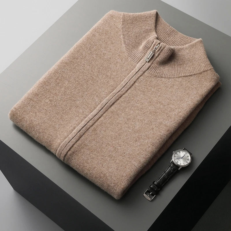 Folded men's beige zip-up knit sweater vest featuring a stand collar and premium knit texture.