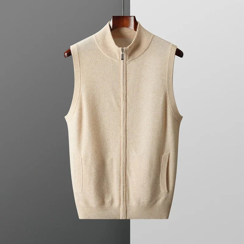 Men's light beige knit zip-up sweater vest with a stand collar, sleeveless design, and ribbed hem displayed on a hanger.